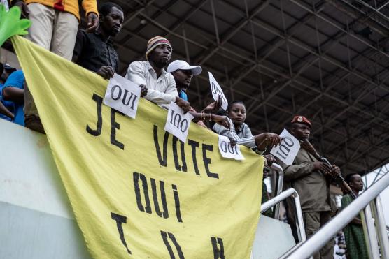 Supporters in favour of amending the constitution hold posters urging to vote yes in the upcoming referendum at the last campaign meeting, in Bangui, on July 28, 2023. Voters in the flashpoint Central African Republic will vote in a referendum on July 30, 2023 in a controversial plan to change the constitution, opening the door to a third term by President Faustin Archange Touadera. (Photo by Barbara DEBOUT / AFP)